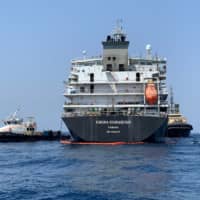A picture taken during a guided tour by the U.S. Navy (NAVCENT) shows the Japanese oil tanker Kokuka Courageous off the port of the Gulf emirate of Fujairah on Wednesday. The tanker attacked in the Gulf of Oman last week was damaged by a limpet mine resembling Iranian mines, the U.S. military in the Middle East said. | AFP-JIJI
