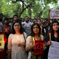 Indians hold placards condemning the recent mob lynching of Muslim youth Tabrez Ansari in Jharkhand state as they listen to a speaker during a protest in New Delhi Wednesday. Since Prime Minister Narendra Modi took the helm of government, Hindu mobs have lynched dozens of people, mainly Muslims and lower-caste Dalits. | AP