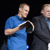 U.S. President Donald Trump listens while pastor David Platt speaks at the McLean Bible Church in Vienna, Virginia,Sunday. | BLOOMBERG