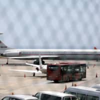 An airplane with the Russian flag is seen at Simon Bolivar International Airport in Caracas Monday. | REUTERS