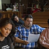 Attorney Roberto Lopez (center) and pastor Jacobita Cortes fparticipate in an emergency meeting plan of action on how to defend and protect undocumented communities of deportation at Lincoln Methodist Church in Chicago\'s Pilsen neighborhood Wednesday. With renewed pledges on mass deportations, immigrant rights activists have fine-tuned and ramped up one of their most basic organizing tools: The know-your-rights training. | AP