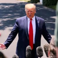 U.S. President Donald Trump speaks to the press as he departs the White House in WashingtonWednesday. Trump is traveling to Osaka for the G20 Summit. | AFP-JIJI