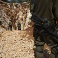 Israeli soldiers stand outside a tunnel that the army says crosses from Lebanon to Israel, in Zarit, northern Israel, Monday. | AP
