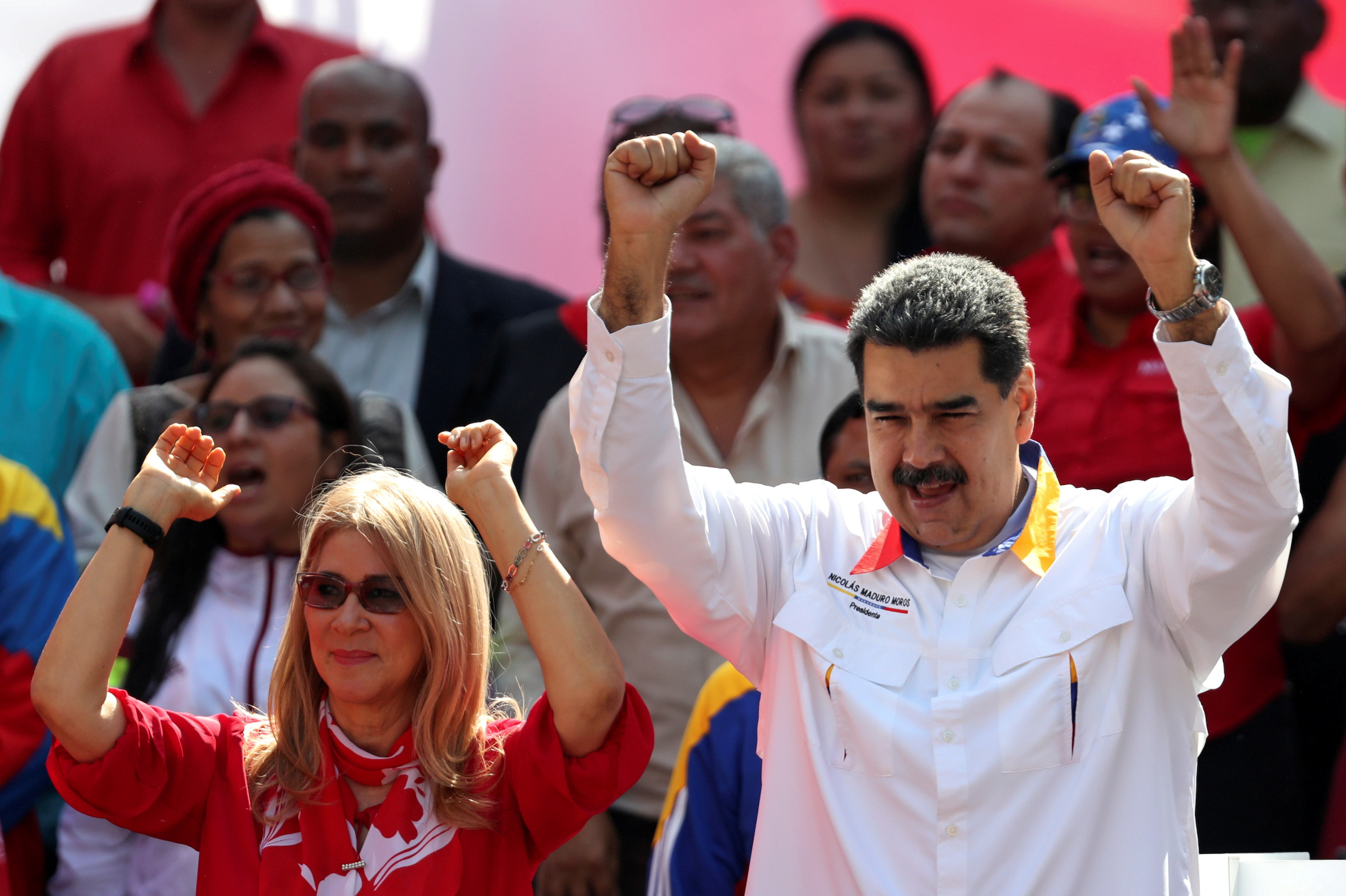 Venezuelan President Nicolas Maduro and his wife, Cilia Flores, greet people during a rally in support of the government in Caracas in May. | REUTERS