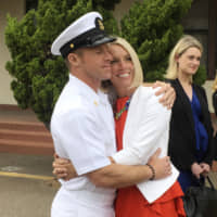 U.S. Navy Special Operations Chief Edward Gallagher hugs his wife, Andrea Gallagher, after leaving a military courtroom on Naval Base San Diego on Thursday. | AP