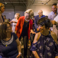 Democratic presidential candidate Elizabeth Warren speaks to Lisa Flynn Scroggins (left) of South Bend, Indiana, and Wendy Silver of Bristol, during her Elkhart Community Conversation event on Wednesday at the RV/MH Hall of Fame and Museum in Elkhart, Indiana. | ROBERT FRANKLIN / SOUTH BEND TRIBUNE / VIA AP