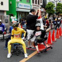 Contestants take part in the office chair race \"Isu-1\" Grand Prix held in Hanyu, Saitama Prefecture, on Sunday. | REUTERS