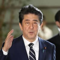 Prime Minister Shinzo Abe enters his office Wednesday to attend a Cabinet meeting. | KYODO