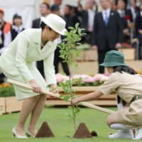 Empress Masako plants a tree during a national tree-planting ceremony in Owariasahi, Aichi Prefecture, on Sunday in her first official duty outside Tokyo since Emperor Naruhito ascended the throne on May 1. | KYODO