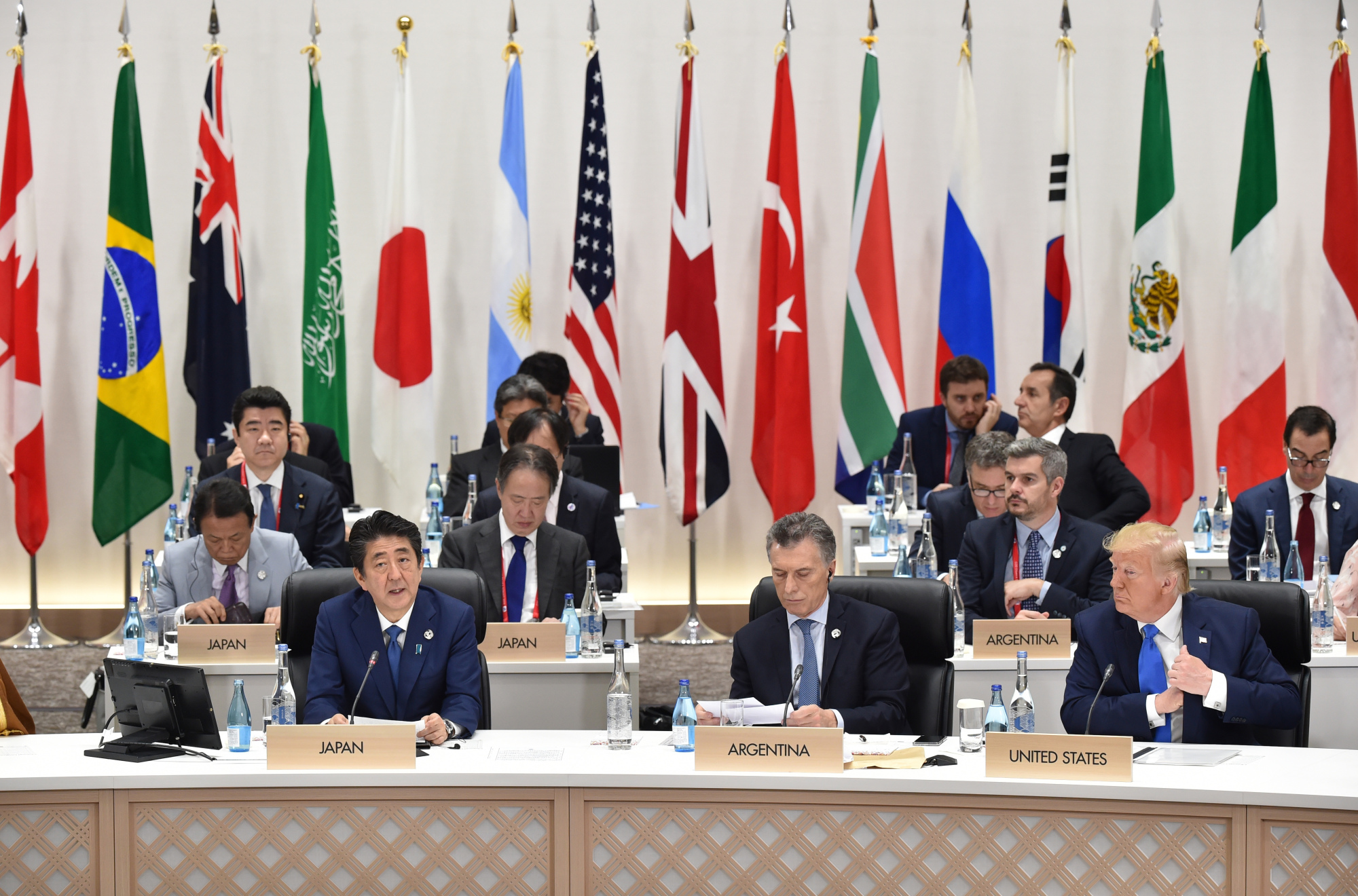 Prime Minister Shinzo Abe speaks as Mauricio Macri, president of Argentina, and U.S. President Donald Trump attend a session at the Group of 20 summit in Osaka on Saturday. | BLOOMBERG
