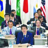 Prime Minister Shinzo Abe speaks on female participation in the workforce, the future of work and aging societies during the G20 Summit in Osaka on Saturday. | AFP-JIJI