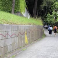 Red lines can be seen spanning dozens of meters of a stone wall that surrounds the Akasaka Estate in Tokyo, in this photo taken Tuesday. | KYODO