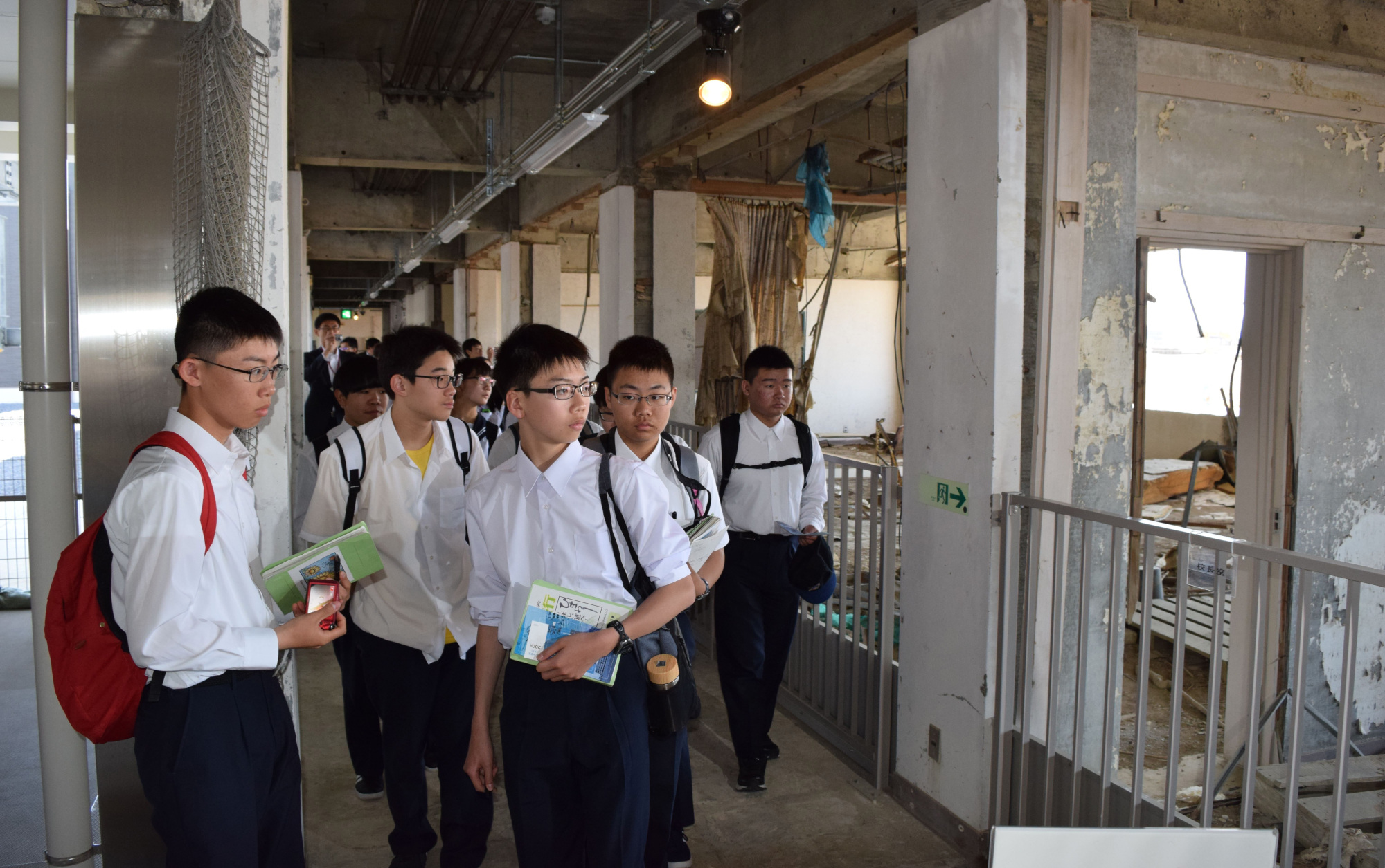 Junior high school students look around the Ruins of the Great East Japan Earthquake Kesennuma City Memorial Museum during a school trip in May. | KAHOKU SHIMPO