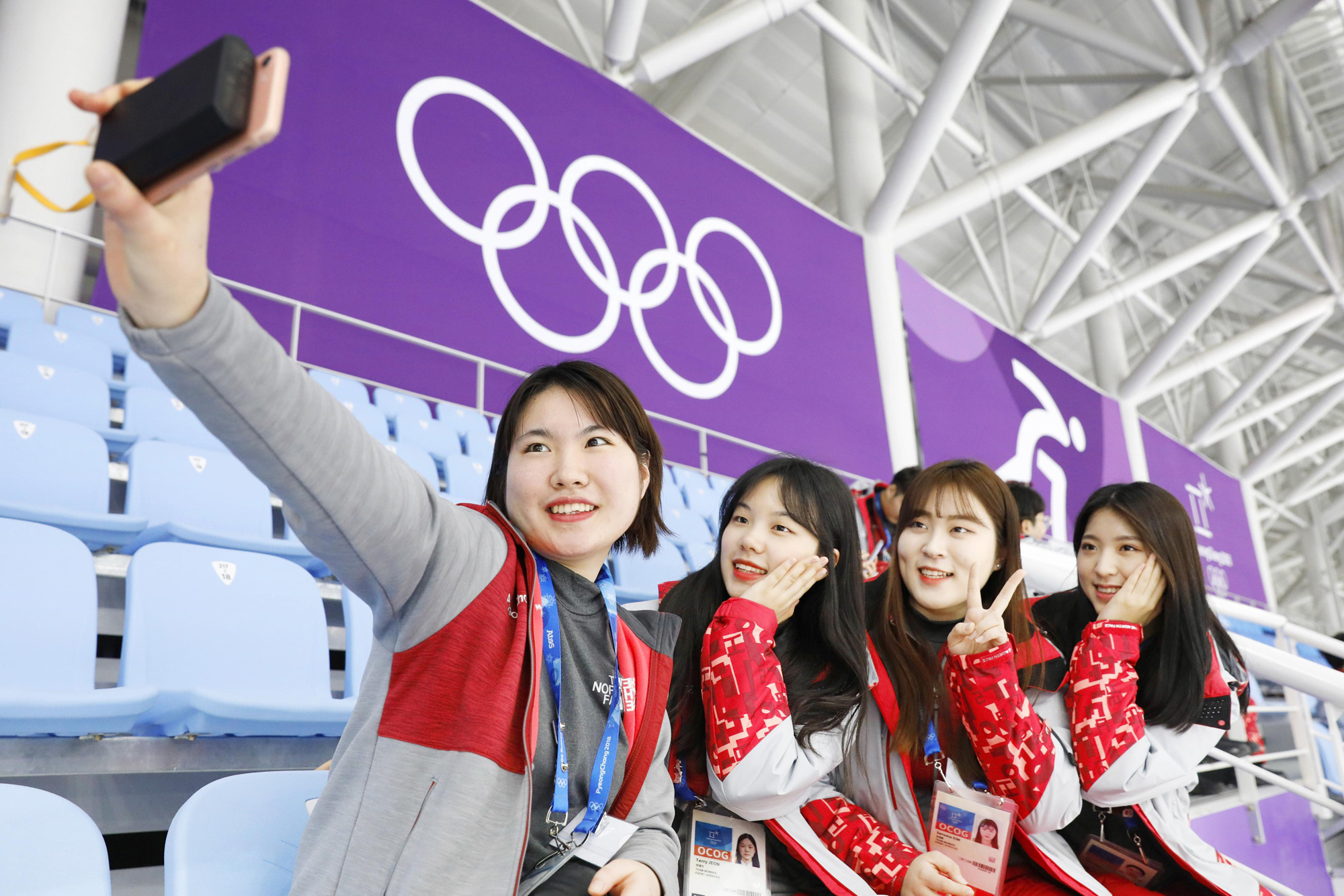 Volunteer workers take selfies at the speedskating venue for the Pyeongchang Winter Olympics in Gangneung, South Korea, on Feb. 8, 2018, the day before the games opened. | KYODO