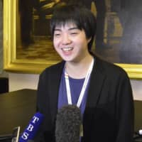 Mao Fujita speaks to reporters Thursday in Moscow after tying for second place in the piano category of the 16th International Tchaikovsky Competition. | KYODO