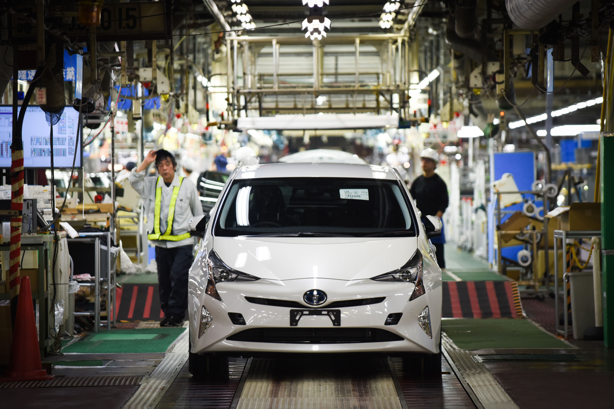 A Prius hybrid automobile goes through a final quality check on the production line at Toyota Motor Corp.'s plant in Toyota, Aichi Prefecture, in 2017. | BLOOMBERG