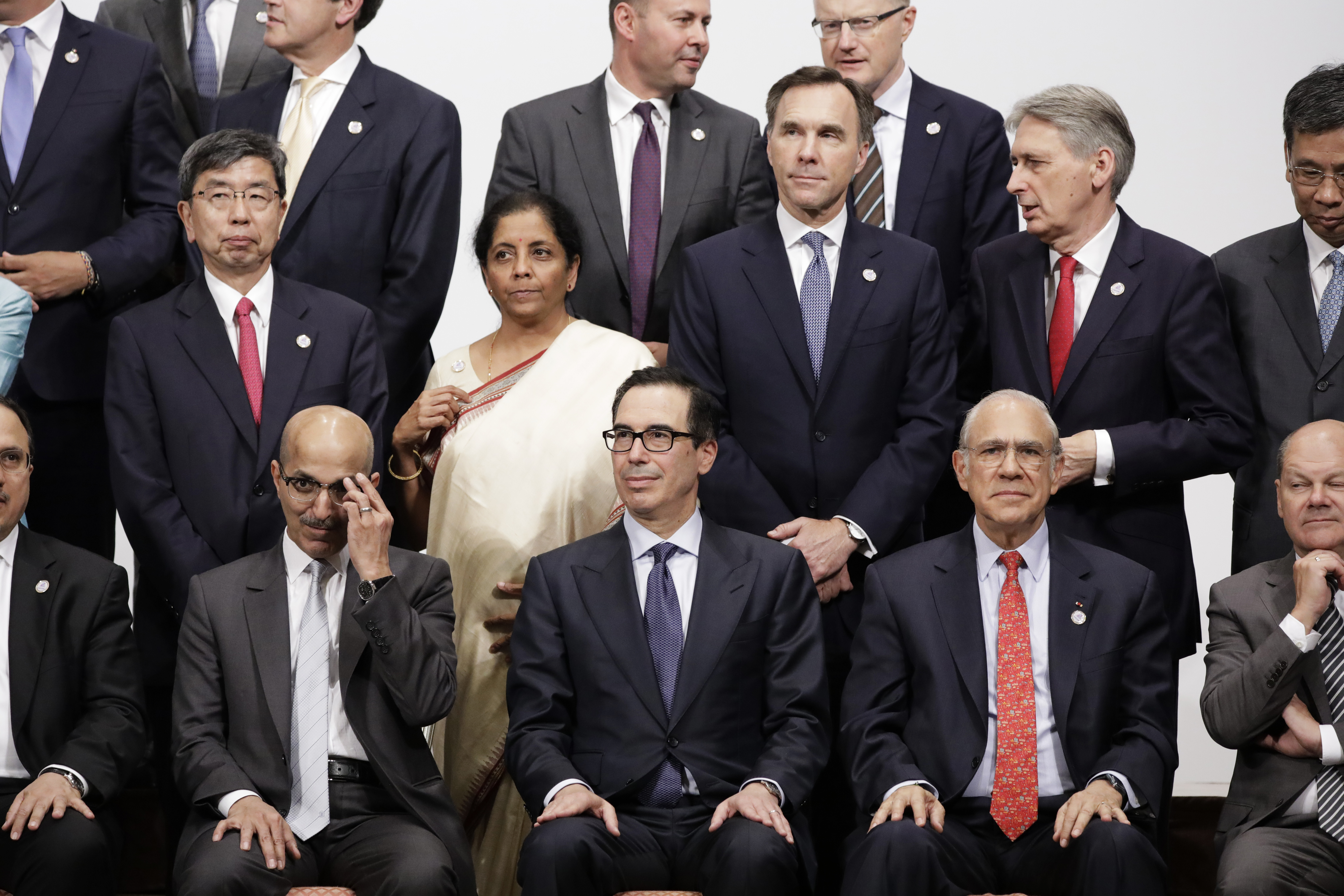 Group of 20 finance ministers and central bank governors get ready for a family photo in Fukuoka on June 9. | BLOOMBERG