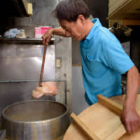 Better than bacon?: Noyama Shoten owner Yoshikazu Noyama boils salted pork until the fat is rendered and the meat is juicy. | TSUYOSHI TAGAWA