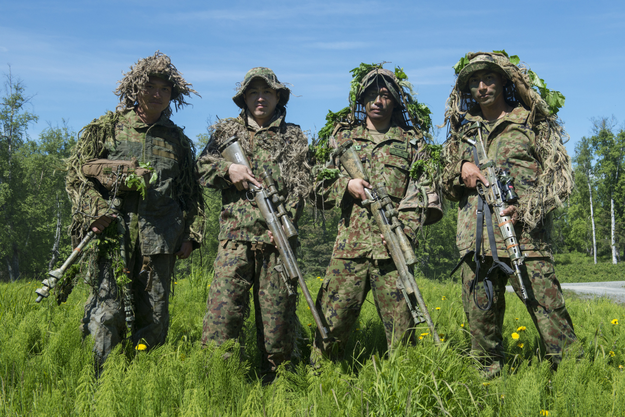 Sniper teams from the Ground Self-Defense Force's 1st Airborne Brigade take a break during the Arctic Aurora exercise held with elements of the U.S. Army in Alaska on June 5. The single most precarious issue facing the SDF is Japan's looming demographic crisis, which is reducing the pool of young people from which to recruit. | JOINT BASE ELMENDORF-RICHARDSON PUBLIC AFFAIRS