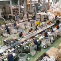Workers sorting used foam food trays at FP Corp.\'s Kanto Recycling Plant in Yachiyo, Ibaraki Prefecture. | FP CORP.