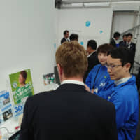 FPCO employees explain the firm\'s eco efforts on June 15 at the Group of 20 Innovation Exhibition for Earth, Society and the Future in Karuizawa, Nagano Prefecture. | FP CORP.