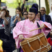 Members of the Japanese  street performance group Chin-don Tsushinsha play as they march down Michigan Avenue to celebrate the 45th anniversary of the sister city partnership between Chicago and Osaka on June 6, 2018. | AP