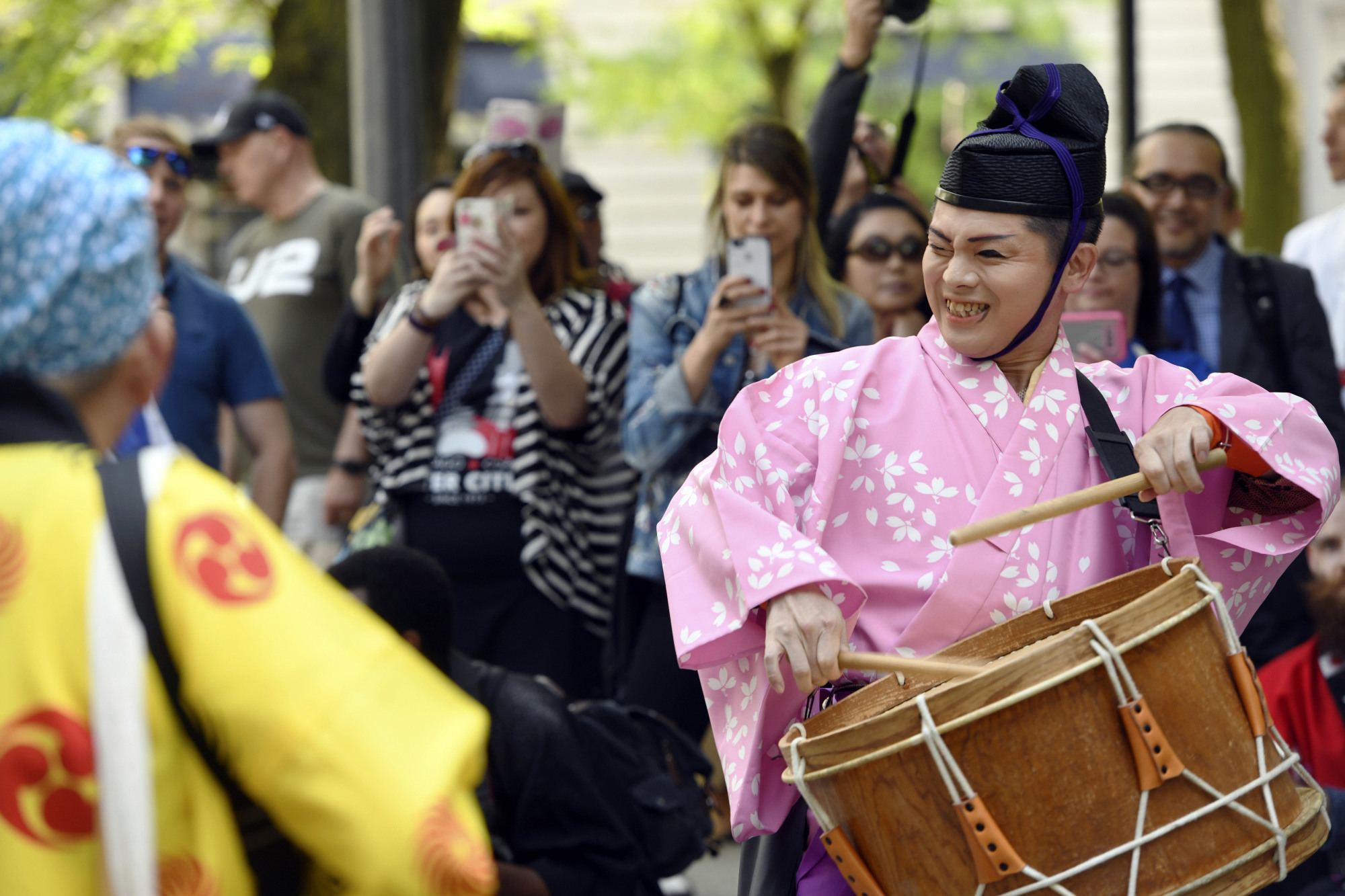 Members of the Japanese  street performance group Chin-don Tsushinsha play as they march down Michigan Avenue to celebrate the 45th anniversary of the sister city partnership between Chicago and Osaka on June 6, 2018. | AP