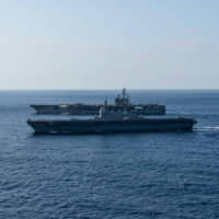 The Maritime Self-Defense Force helicopter carrier Izumo sails with the USS Ronald Reagan on June 19 while conducting operations in the South China Sea, which has emerged as a dangerous regional flashpoint. | COMMANDER, TASK FORCE 70 / CARRIER STRIKE GROUP 5