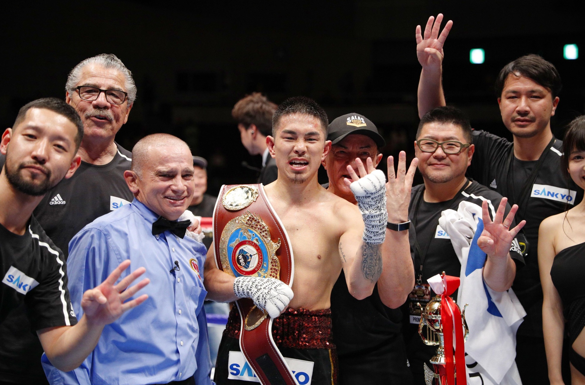 Kazuto Ioka (center) celebrates in the ring after his victory over Aston Palicte for the vacant WBO super flyweight championship on Wednesday night at Makuhari Messe in Chiba. The victory made Ioka the first Japanese man to win world titles in four different weight classes. | KYODO