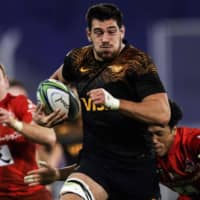The Jaguares\' Guido Petti runs with the ball past the Sunwolves\' Takuya Yamasawa (right) during a Super Rugby match on Friday in Buenos Aires. | AFP-JIJI