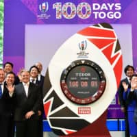 World Rugby CEO Alan Gilpin (front, left), World Rugby COO Brett Gosper (front, second from left) and Rugby World Cup Organizing Committee President Fujio Mitarai (front, right) participate in a countdown event for the 2019 Rugby World Cup on Wednesday in Tokyo. | AFP-JIJI
