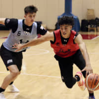 Guard Chikara Tanaka attacks the basket while being guarded by Kai Toews at the Japan men\'s national development training camp at the National Training Center on Friday. | KAZ NAGATSUKA