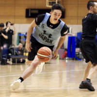 Point guard Kai Toews dribbles on Friday during a Japan men\'s national development training camp practice at the National Training Center on Friday. | KAZ NAGATSUKA
