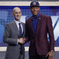 NBA commissioner Adam Silver poses with Rui Hachimura after the Washington Wizards selected him as the ninth pick in the first round of the NBA Draft on Thursday night in New York. | AP