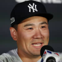 Yankees pitcher Masahiro Tanaka speaks to the media at a news conference in London on Friday. | AP