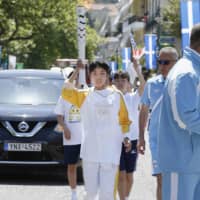 Junior high school students from Inazawa, Aichi Prefecture, take part in a torch relay for the Rio Olympics in April 2016 in Olympia, Greece. Inazawa students will also participate in the torch relay for the 2020 Tokyo Games in Greece. | KYODO