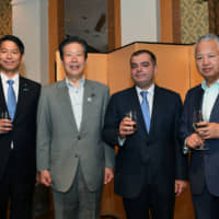 Farid Talibov (second from right), charge d\' affaires ad interim for the Azerbaijan Embassy, poses with (from left) Parliamentary Vice-Minister for Foreign Affairs Kenji Yamada, Komeito chief Natsuo Yamaguchi and Chairman of the Japan-Azerbaijan Parliamentary Friendship Association Akira Amari during a reception to celebrate Azerbaijan\'s national day and the 100th anniversary of Azerbaijan\'s diplomatic service at Okura Hotel Tokyo on May 24. | YOSHIAKI MIURA