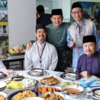 The Malaysian Embassy held an open house in conjunction with Eid al-Fitr, a festive celebration marking the end of Ramadan. The embassy served various festive foods at the event, which was attended by 650 members of the Malaysian community, students and honorary guests. Yoko Sakurai (far left), an official in the Foreign Ministry, poses with (from second from left) Foreign Ministry Second Southeast Asia Division Director Shingo Miyamoto, Malaysian Investment Development Authority (MIDA) Tokyo Director Mohd Riduan Abd Rahman, I.M. Jihan Managing Director Steven Ozeki Tan and Malaysian Ambassador Dato\' Kennedy Jawan at the celebration on June 5. | COURTESY OF THE MALAYSIAN EMBASSY