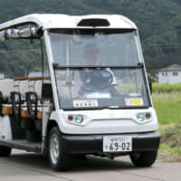 An experiment aimed at transporting residents and tourists on public roads using self-driving cars is conducted in the city of Eiheiji, Fukui Prefecture, on Monday. The trial on the 6-kilometer road is to take place for six months, making it the longest experiment of its kind in Japan, Eiheiji government officials said. | KYODO