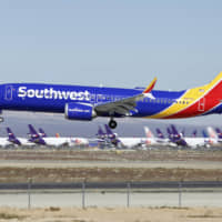 A Southwest Airlines Boeing 737 Max aircraft lands at the Southern California Logistics Airport in the high desert town of Victorville, California, in March. | AP