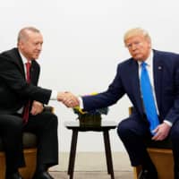 U.S. President Donald Trump (right) shakes hands during a bilateral meeting with Turkish President Tayyip Erdogan during the G20 leaders summit in Osaka June 29. | REUTERS