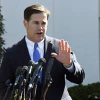 Arizona Gov. Doug Ducey talks to reporters outside the West Wing of the White House in Washington in April. Ducey is yanking a grant of up to &#36;1 million from Nike amid a report that the athletic company pulled a flag-themed shoe from the market. | AP