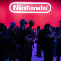 Attendees wait to enter the Nintendo Co. Pokemon Sword and Shield exhibit during the Electronic Entertainment Expo in Los Angeles on June 11. | BLOOMBERG
