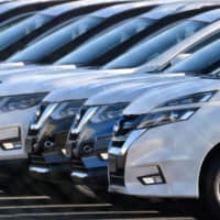 Nissan Motor Co. vehicles are lined up in Yokosuka, Kanagawa Prefecture, in January. The alliance of Nissan, Renault SA and Mitsubishi Motors Corp. lost its lead in global auto sales in the first half of 2019. | BLOOMBERG