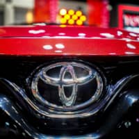 Toyota\'s logo is seen in an auto salon in Bangkok. | REUTERS