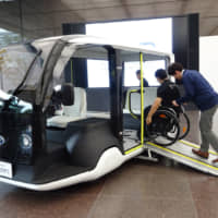 Toyota Motor Corp. shows off an electric vehicle designed to transport people around venues for the 2020 Olympics, at its headquarters in Tokyo on Thursday. | KAZUAKI NAGATA