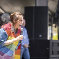 Sen. Kamala Harris, a Democrat from California and 2020 presidential candidate, laughs while speaking during the San Francisco Pride Parade in San Francisco on Sunday. Harris\'s profile has risen since Thursday\'s debate, where she challenged former Vice President Joe Biden\'s record of opposing federal mandates to desegregate schools through the use of busing. | BLOOMBERG