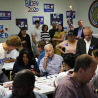 Former Vice President and Democratic presidential candidate Joe Biden speaks on the phone during a campaign phone bank event an electrical workers union hall Saturday in Las Vegas. | AP