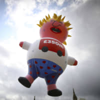 A blimp depicting Boris Johnson flies above Parliament Square in London on Saturday ahead of a pro-European Union march organized by March for Change. | AP