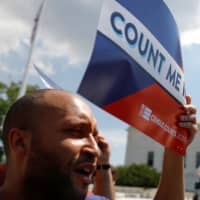 A protester holds a sign outside the U.S. Supreme Court, which ruled that U.S. President Donald Trump\'s administration did not give an adequate explanation for its plan to add a citizenship question to the 2020 census, delivering a victory to New York state and others challenging the proposal, in Washington on June 27. | REUTERS